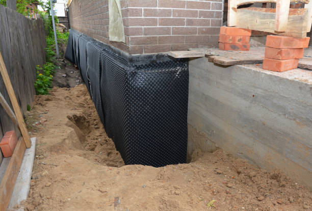 SJ Waterproofing Pros technician performing targeted Waterproofing assessment in Osseo, MN